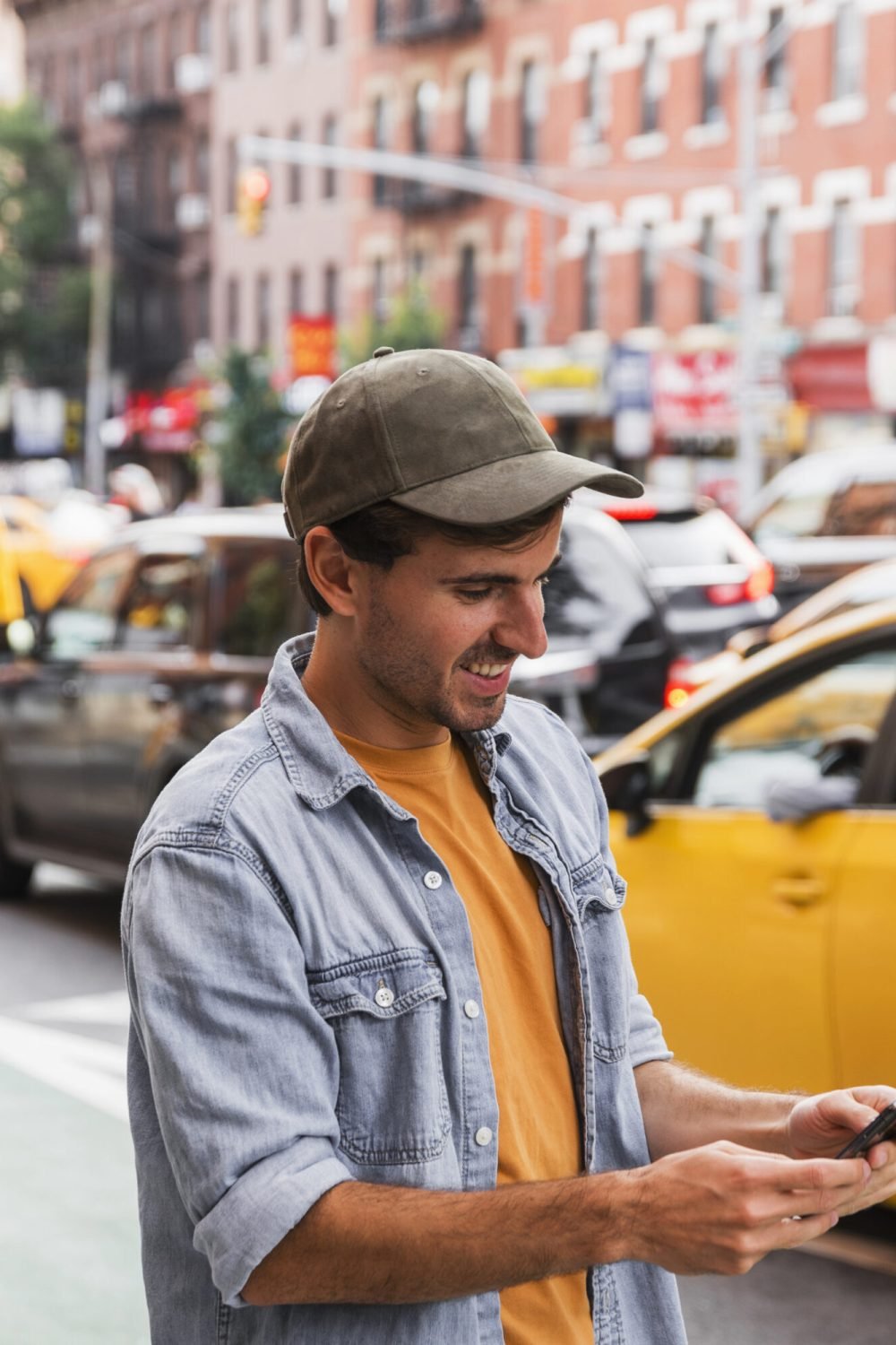 man-with-cap-looking-mobile